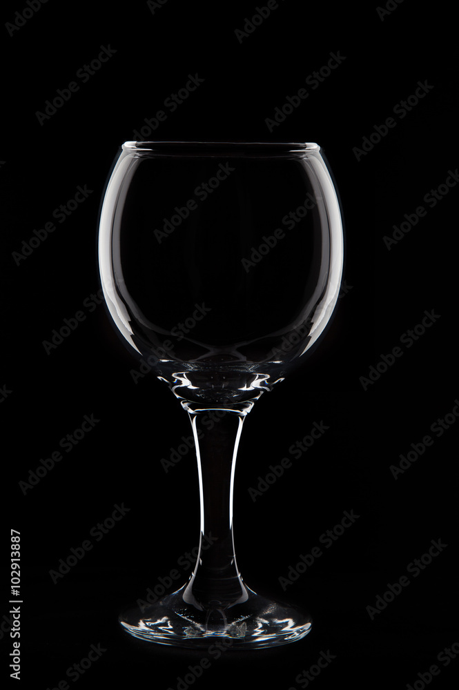 Empty wine glass on black background in studio Empty wine glass on black background in studio