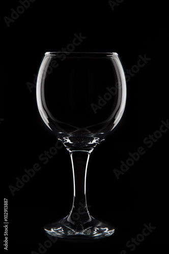 Empty wine glass on black background in studio