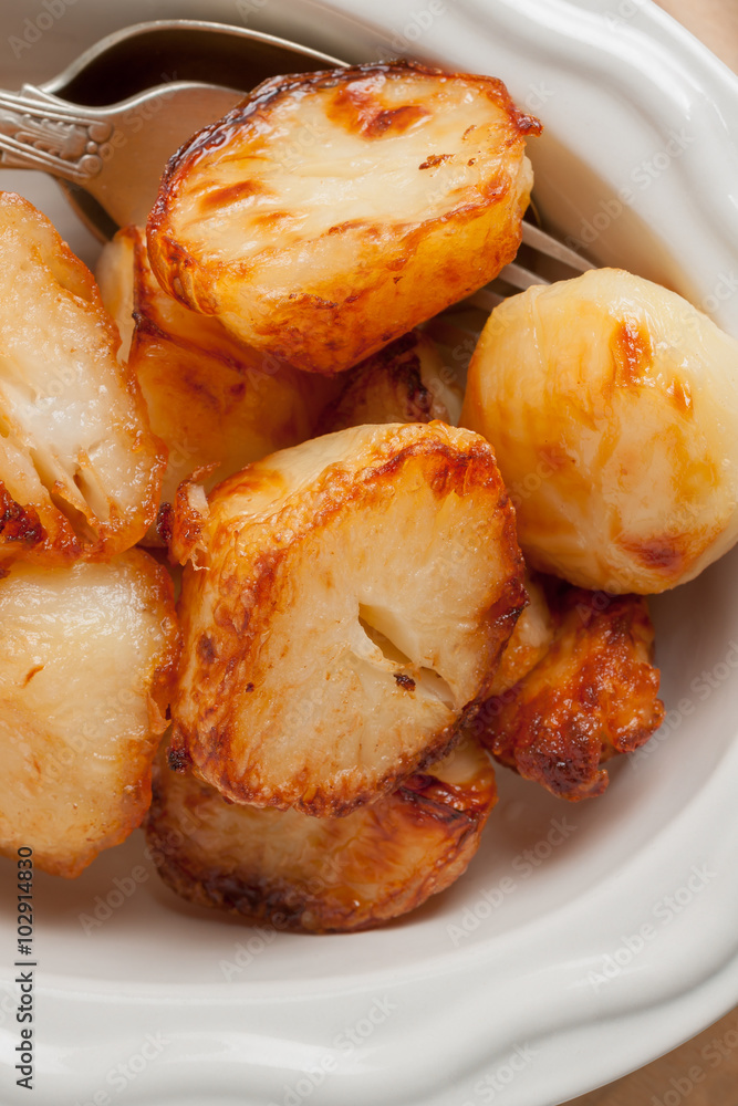 Roast Potatoes cooked in beef fat until crisp and golden a favourite side dish with roast dinners Roast Potatoes cooked in beef fat until crisp and golden a favourite side dish with roast dinners