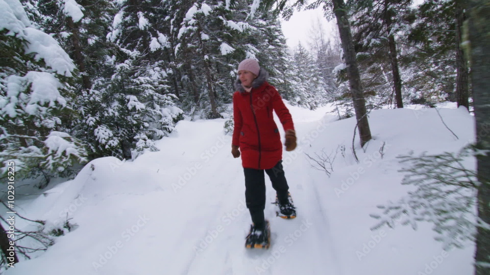 Steadicam Front view of Happy Woman Snowshoeing in Forest Steadicam Front view of Happy Woman Snowshoeing in Forest