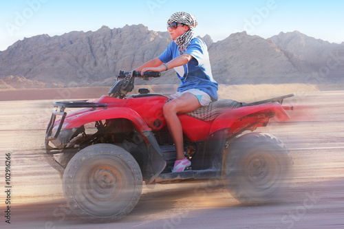 Girl on the ATV goes with high speed