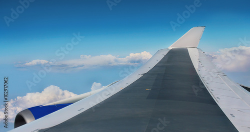 View of plane wing in sky from window
