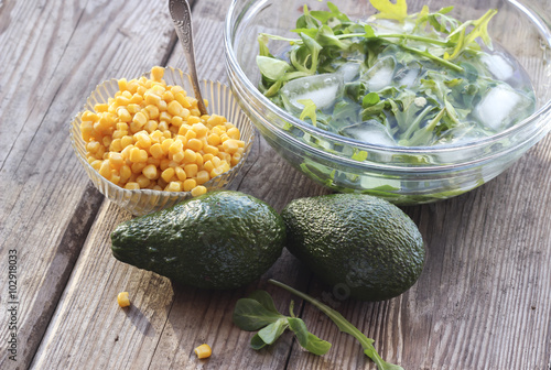 Ingredients for salad with avocado, arugula, mung bean leaves an
