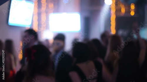 Blurred footage of crowded hall at night club with dancing young people around  students hanging out at their prom night, young people are celebrating wedding.