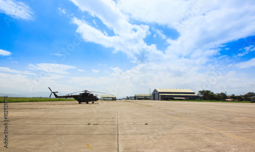 military airport , a helicopter on the runway