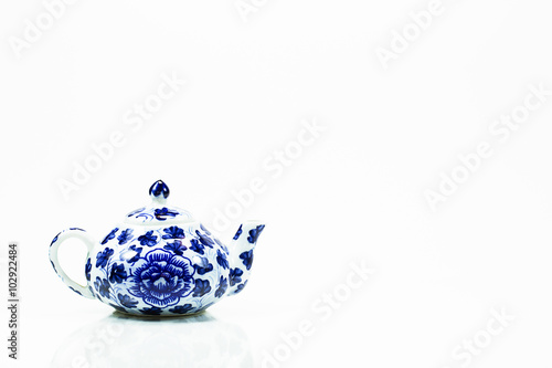 Vintage blue ceramic teapot on white background