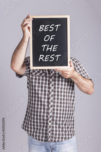 Man holding Best of the rest message written on a blackboard photo