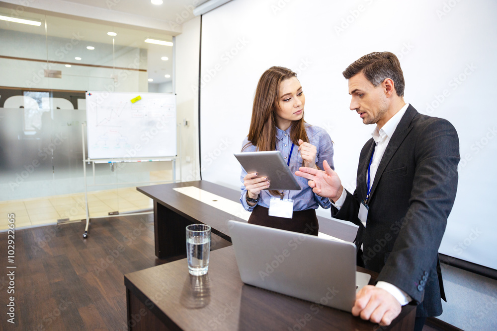 Businessman and his secretary planning work in office Businessman and his secretary planning work in office