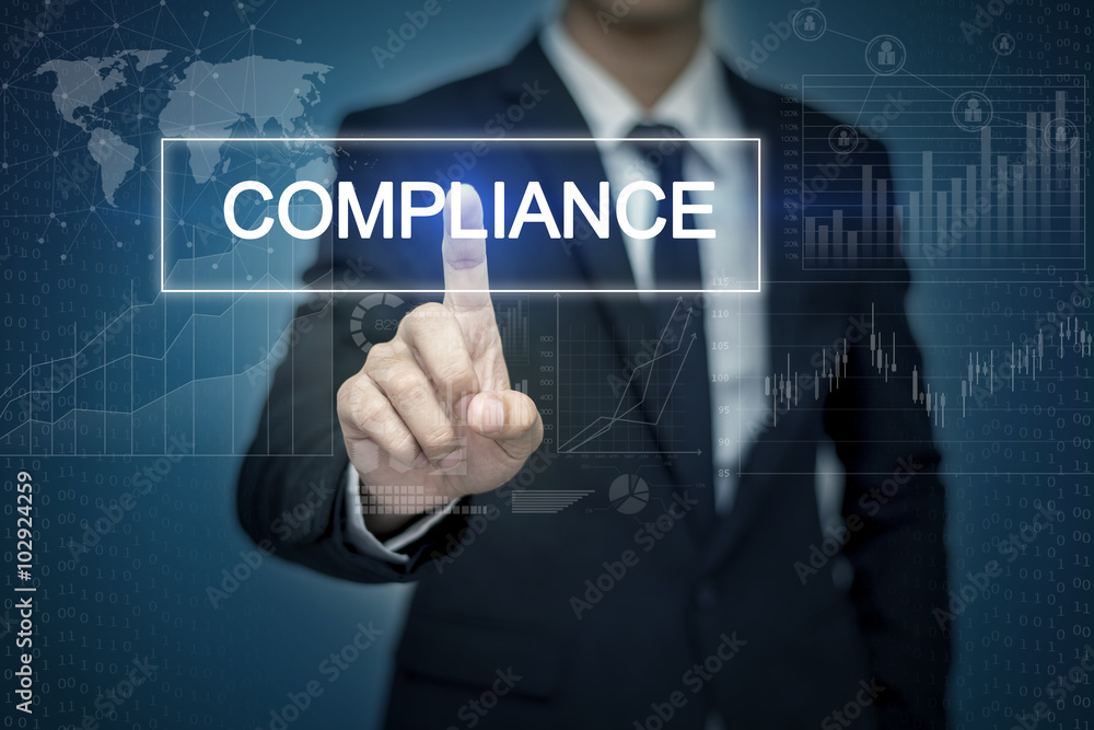 Businessman hand touching COMPLIANCE button on virtual screen Businessman hand touching COMPLIANCE button on virtual screen