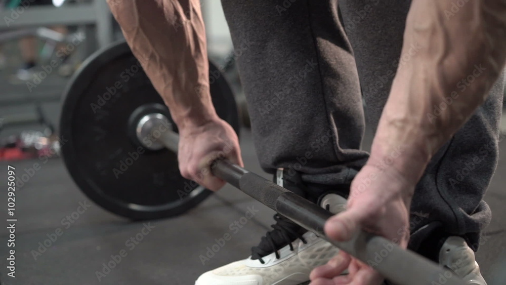 Slowly demonstration of deadlift of strong man with with distinct veins on arms Slowly demonstration of deadlift of strong man with with distinct veins on arms