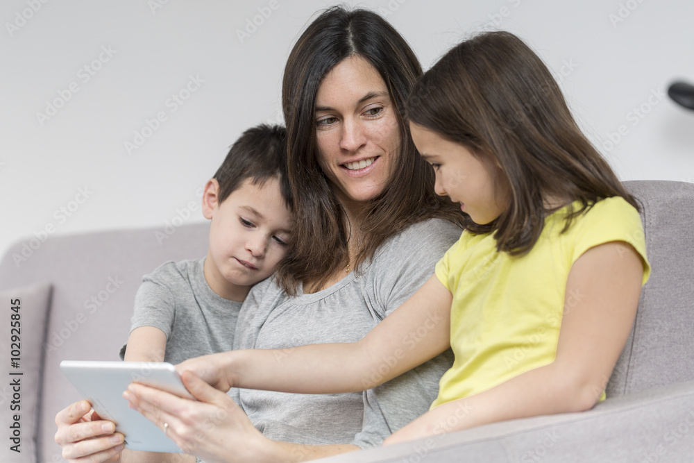 Smiling mother and children using tablet Smiling mother and children using tablet