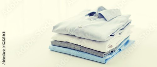 close up of ironed and folded shirts on table