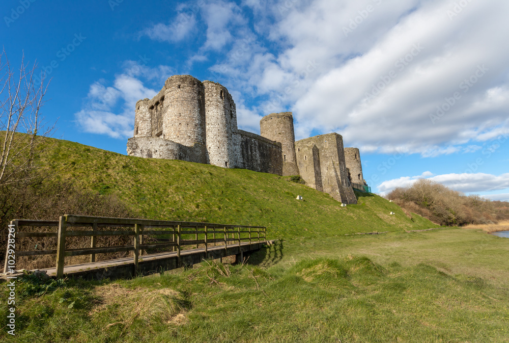 Kidwelly Castle is a Norman castle overlooking the River Gwendraeth and the town of Kidwelly, Carmarthenshire, Wales.
