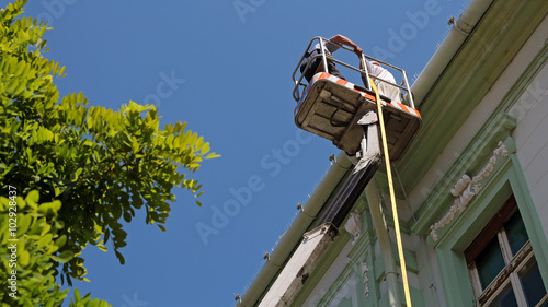 Construction Workers on Hydraulic Platform