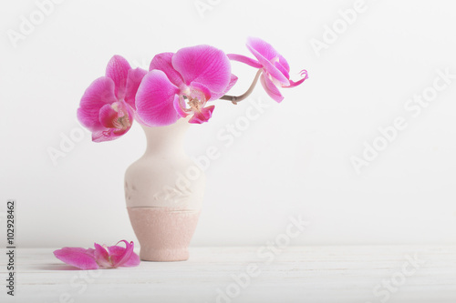 Fototapeta Naklejka Na Ścianę i Meble -  orchid flowers in vase on a wooden table
