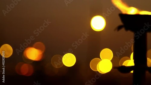 Pan shot of an oil lamp burning at Kumbh Mela festival, Allahabad, Uttar Pradesh, India photo