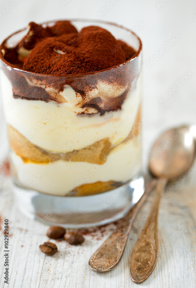 tiramisu in glass on wooden surface tiramisu in glass on wooden surface