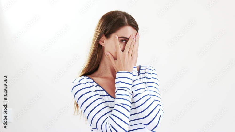 Woman hiding her face with her hands Woman hiding her face with her hands