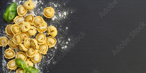 Homemade raw Italian tortellini and basil