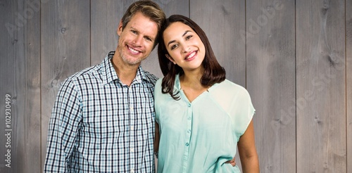 Composite image of portrait of happy couple standing