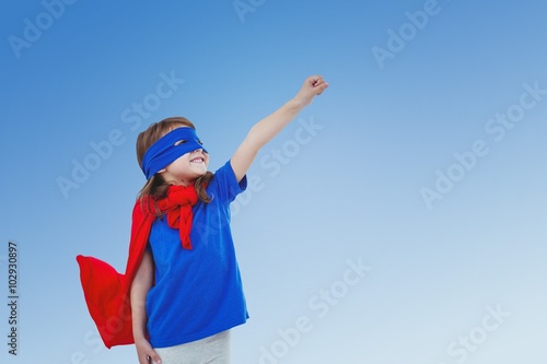 Composite image of masked girl pretending to be superhero