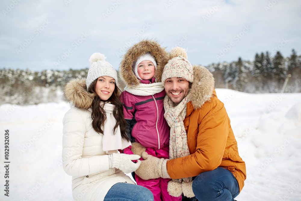 Obraz premium happy family with child in winter clothes outdoors