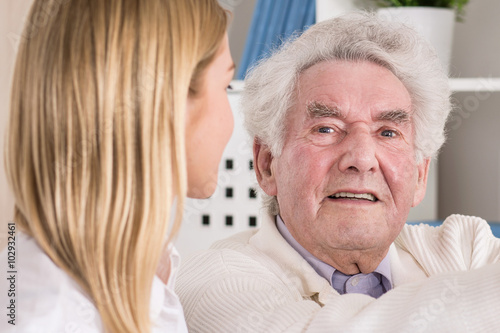 Quadro su tela Elderly man looking at young woman