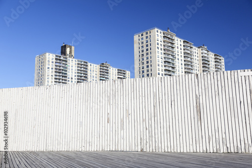 derelict part of coney island boardwalk and apartment buildings
