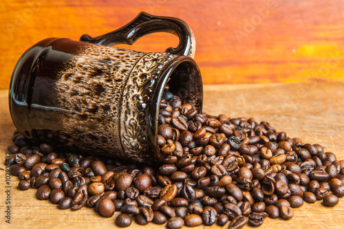 Roasted coffee beans arange to coffee cup  photo