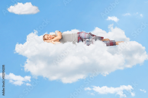 Tranquil scene of a woman sleeping on cloud