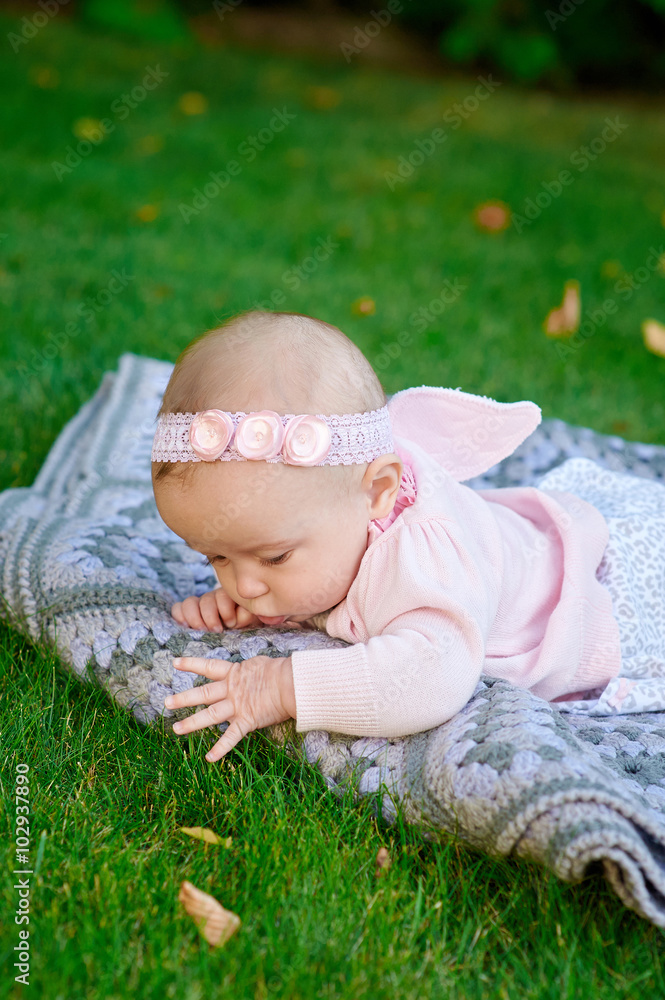 Little girl playing on the grass in the summer park Little girl playing on the grass in the summer park