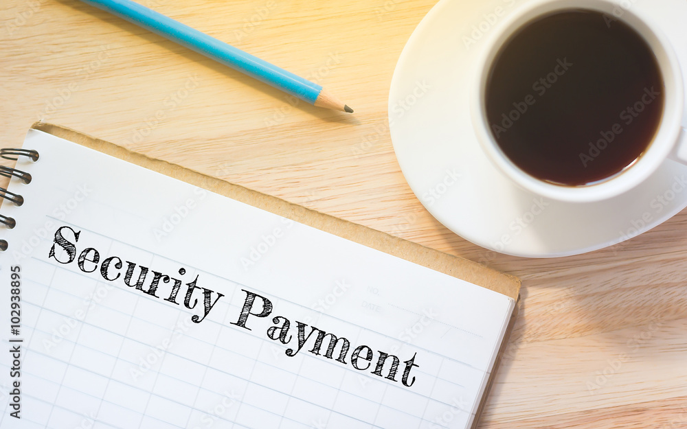Concept Security Payment message on book. A pencil and a glass coffee table.Vintage tone. Concept Security Payment message on book. A pencil and a glass coffee table.Vintage tone.