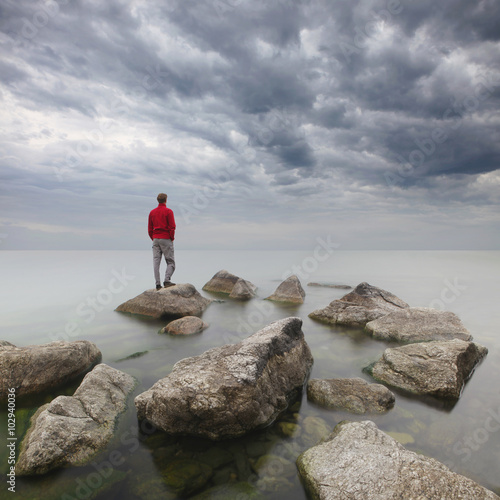 Man staring at the sea. photo