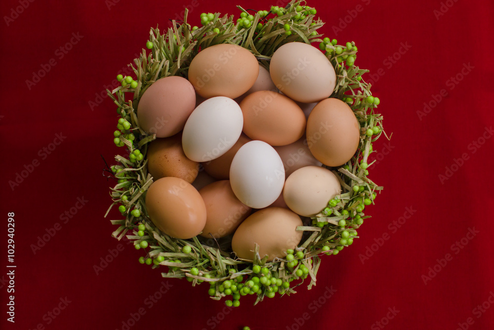 Eggs in a basket on a red background close-up Eggs in a basket on a red background close-up