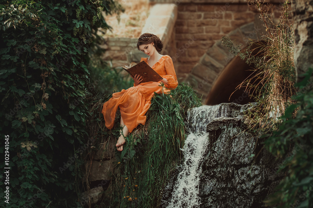 The beautiful countess in a long orange dress sits near a source of water and reading a book, elf, Princess in vintage dress, the queen of the forest,fashionable toning creative computer colors