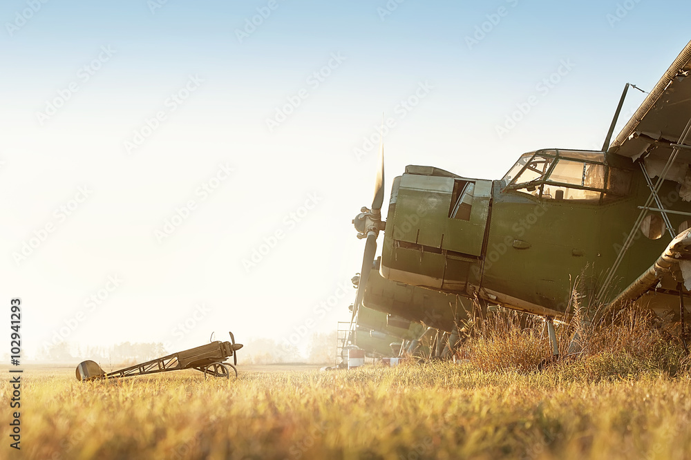 Fototapeta premium Child model airplane parked with retro airplanes