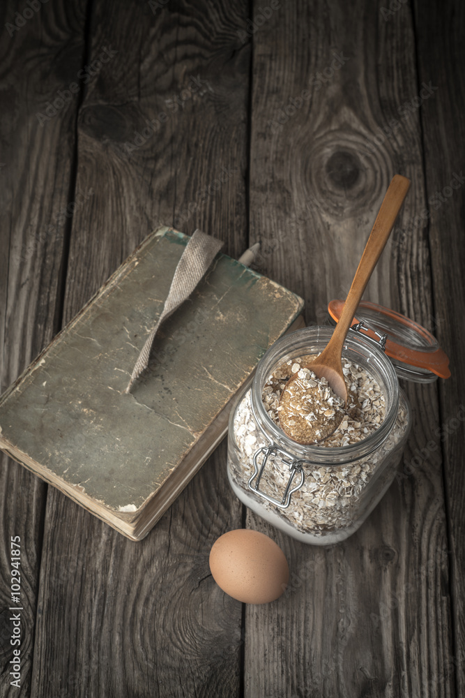 Book of recipes and ingredients for cookies on a wooden table Book of recipes and ingredients for cookies on a wooden table