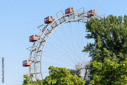 Fun Park Ferris Wheel Against Blue Sky In Vienna Prater Park