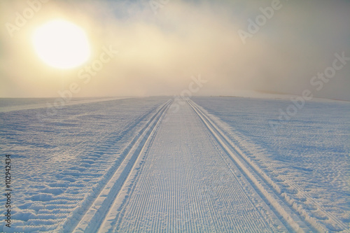ski path on snow at sunrise