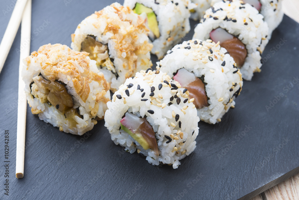 Sushi rolls on a slate plate Sushi rolls on a slate plate