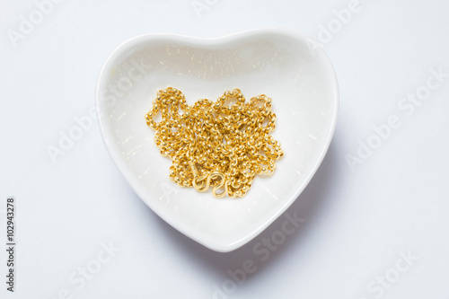 gold necklaces in heart shape bowl gift for lover or economy bus