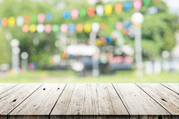 Empty wooden table with blurred party on background
