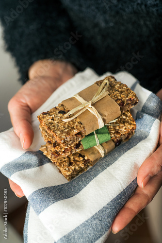 Holding delicious homemeade granola bars photo