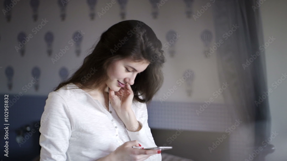 Beautiful young girl writes a message. She dreams and smiles
