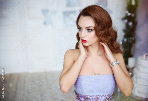 Romantic red-haired woman in bright room