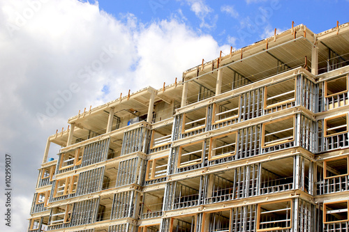 Construction site of residential building on blue sky background