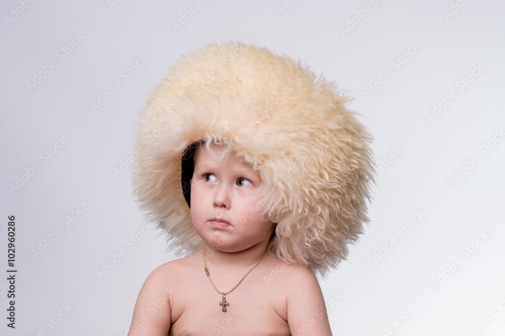 Portrait of a boy wearing funny furry winter hat