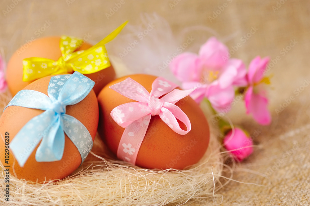 Easter eggs in the nest on a burlap Easter eggs in the nest on a burlap