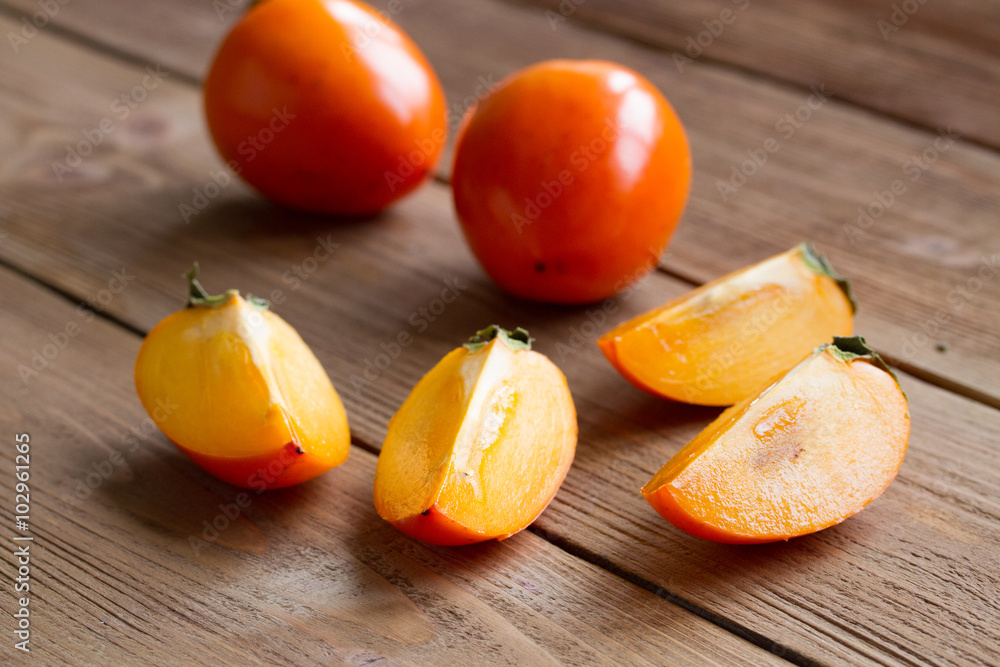 ripe persimmon on a wooden background