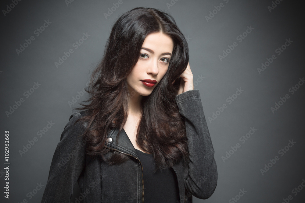 Fashion model woman with dark red lips in studio